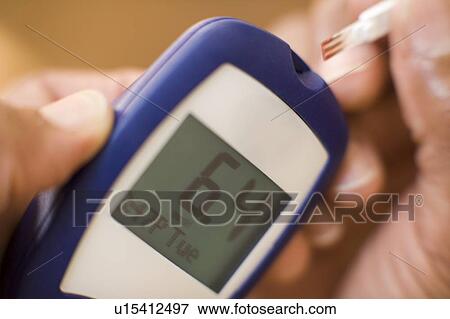 Stock Photo - Blood glucose testing. Fotosearch