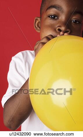 Stock Image - Blowing up a balloon. Fotosearch