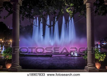 Stock Image - Blue and purple illuminated fountain at night, Park of the Reserve (Parque de la Reserva), Lima, Peru. Fotosearch