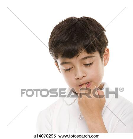 Stock Photography - Boy biting his nails. Fotosearch