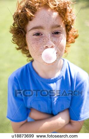 Stock Photo - Boy blowing bubblegum. Fotosearch