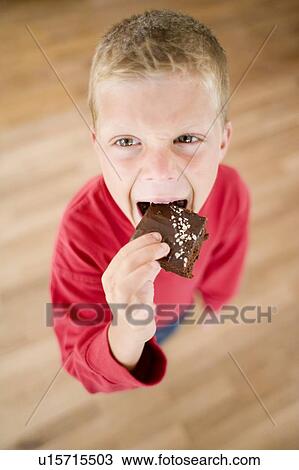 Boy eatng chocolate cake View Large Photo Image Stock Image - Boy eatng chocolate cake. Fotosearch