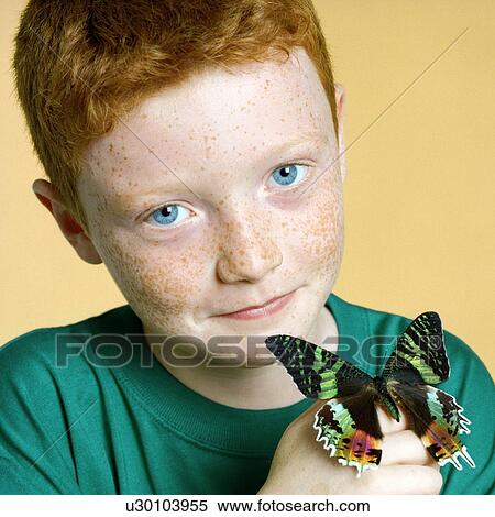 Stock Photography - Boy holding a butterfly. Fotosearch