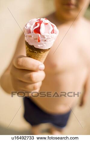 Boy holding an ice cream View Large Photo Image Stock Image - Boy holding an ice cream. Fotosearch
