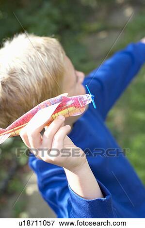 Stock Photo - Boy playing with a toy aeroplane. Fotosearch