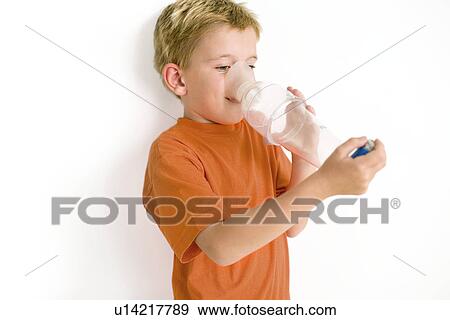Stock Photo - Boy using an asthma spacer. Fotosearch