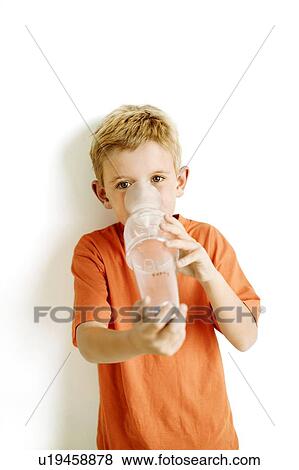 Stock Photo - Boy using an asthma spacer. Fotosearch