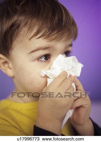 Stock Image - Boy wiping nose. Fotosearch