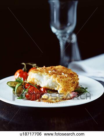 Breaded fish with mediterranean vegetables on white plate View Large Photo Image Stock Photograph - Breaded fish with mediterranean vegetables on white plate. Fotosearch