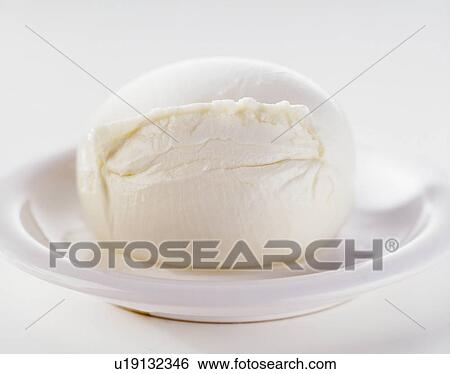 Stock Photograph - Buffalo mozzarella, on white dish, close-up. Fotosearch