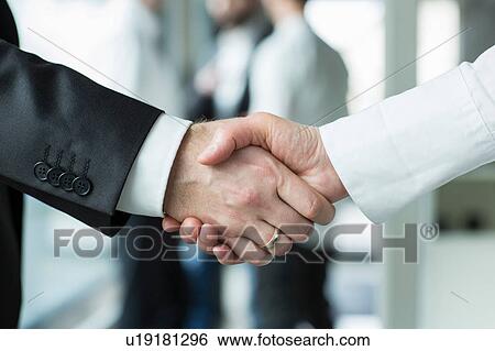 Businessman and businesswoman shaking hands View Large Photo Image Stock Photograph - Businessman and businesswoman shaking hands. Fotosearch
