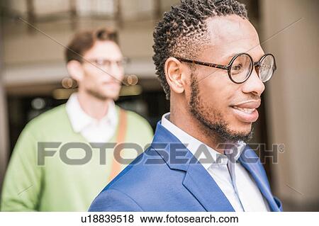 Businessmen leaving office building View Large Photo Image Stock Photo - Businessmen leaving office building. Fotosearch