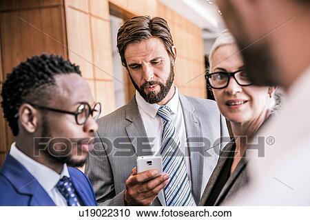 Businesspeople standing in group smiling View Large Photo Image Stock Image - Businesspeople standing in group smiling. Fotosearch