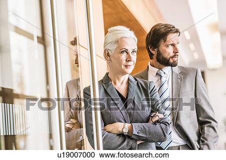 Businesspeople wearing suits looking away View Large Photo Image Stock Image - Businesspeople wearing suits looking away. Fotosearch