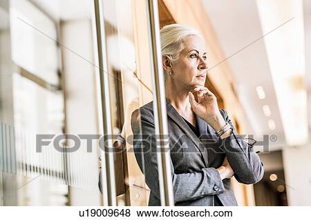 Businesswoman arms crossed hand on chin looking away View Large Photo Image Stock Photo - Businesswoman arms crossed hand on chin looking away. Fotosearch