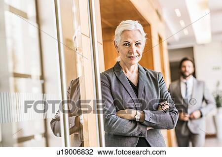 Businesswoman arms crossed looking at camera smiling View Large Photo Image Stock Image - Businesswoman arms crossed looking at camera smiling. Fotosearch