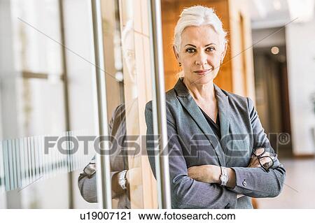 Businesswoman arms crossed looking at camera View Large Photo Image Stock Image - Businesswoman arms crossed looking at camera. Fotosearch
