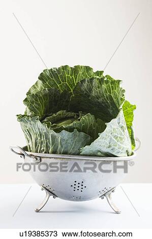 Stock Image - Cabbage leaves in a colander. Fotosearch