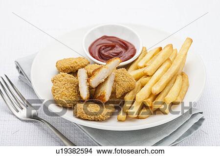 Picture - Chicken nuggets and chips. Fotosearch