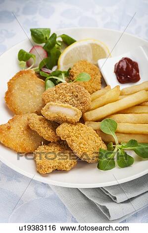 Stock Photograph - Chicken nuggets, chips and salad. Fotosearch