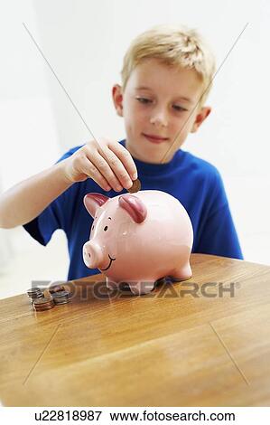 Stock Photo - Child with a piggy bank. Fotosearch