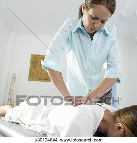 Picture - Chiropractic treatment. Fotosearch