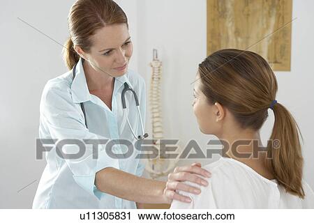 Chiropractor and patient View Large Photo Image Stock Image - Chiropractor and patient. Fotosearch