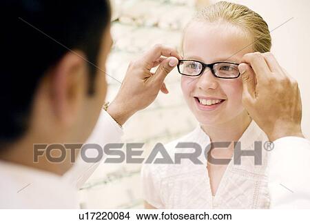 Choosing a pair of glasses View Large Photo Image Picture - Choosing a pair of glasses. Fotosearch