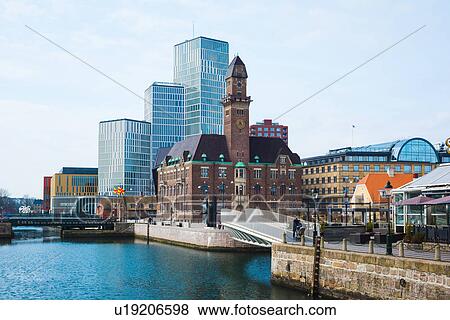 Stock Photo - Clocktower and office blocks on waterfront, Malmo, Sweden. Fotosearch