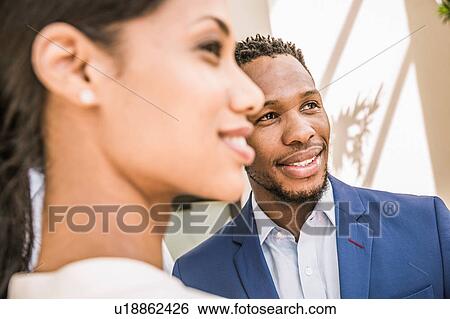 Stock Photograph - Close up of businesswoman and man outside office. Fotosearch