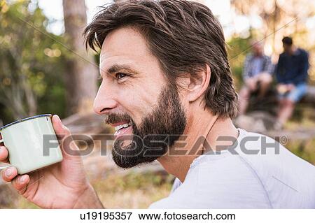 Stock Photo - Close up of man with coffee, Deer Park, Cape Town, South Africa. Fotosearch