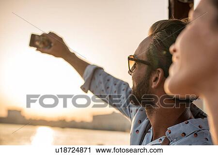 Close up of romantic couple taking smartphone selfie at Dubai marina, United Arab Emirates View Large Photo Image Stock Image - Close up of romantic couple taking smartphone selfie at Dubai marina, United Arab Emirates. Fotosearch