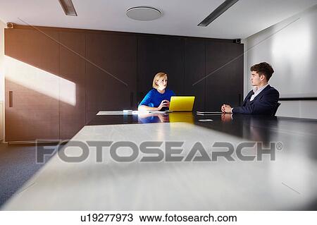Colleagues in conference room at conference table having meeting View Large Photo Image Stock Image - Colleagues in conference room at conference table having meeting. Fotosearch