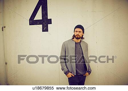 Cool mid adult man leaning against wall number four View Large Photo Image Stock Photography - Cool mid adult man leaning against wall number four. Fotosearch