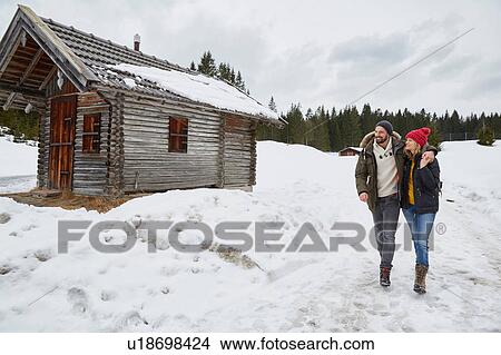 Couple hiking from log cabin in winter, Elmau, Bavaria, Germany View Large Photo Image Picture - Couple hiking from log cabin in winter, Elmau, Bavaria, Germany. Fotosearch