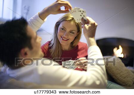 Stock Image - Couple playing cards. Fotosearch