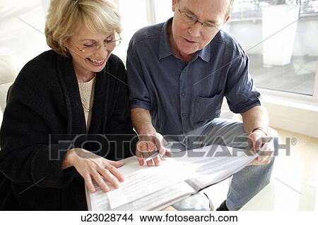 Couple signing forms View Large Photo Image Picture - Couple signing forms. Fotosearch