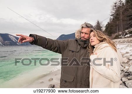 Couple standing beside lake, looking at view, German Alps, Germany View Large Photo Image Stock Image - Couple standing beside lake, looking at view, German Alps, Germany. Fotosearch