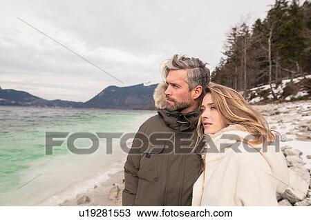 Couple standing beside lake, smiling, German Alps, Germany View Large Photo Image Stock Image - Couple standing beside lake, smiling, German Alps, Germany. Fotosearch