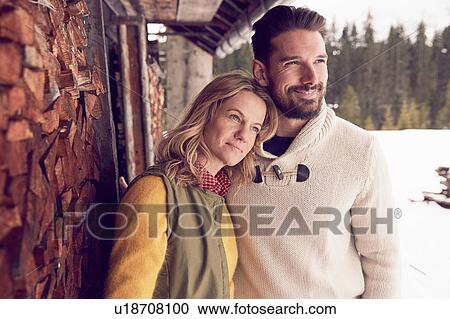 Couple standing outside log cabin in winter, Elmau, Bavaria, Germany View Large Photo Image Stock Image - Couple standing outside log cabin in winter, Elmau, Bavaria, Germany. Fotosearch