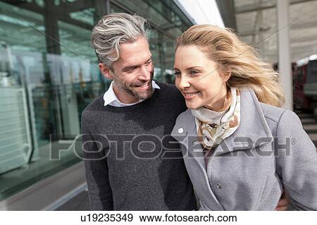 Couple walking together, outdoors, smiling View Large Photo Image Stock Photo - Couple walking together, outdoors, smiling. Fotosearch