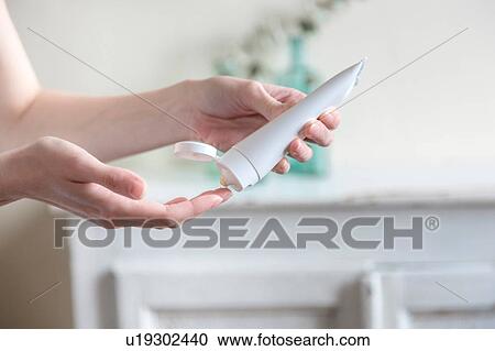 Cropped view of woman squeezing cosmetic cream onto hand View Large Photo Image Stock Image - Cropped view of woman squeezing cosmetic cream onto hand. Fotosearch