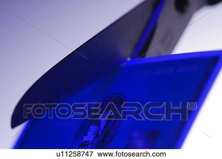 Stock Photo - Cutting up a credit card. Fotosearch