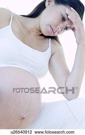 Stock Image - Depressed pregnant woman. Fotosearch