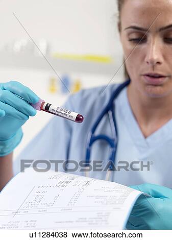 Doctor checking a blood sample View Large Photo Image Stock Photo - Doctor checking a blood sample. Fotosearch