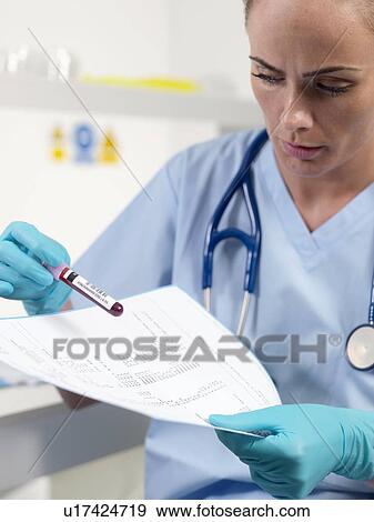 Doctor checking a blood sample View Large Photo Image Stock Photo - Doctor checking a blood sample. Fotosearch