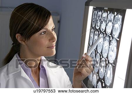 Doctor examining MRI scans View Large Photo Image Stock Image - Doctor examining MRI scans. Fotosearch