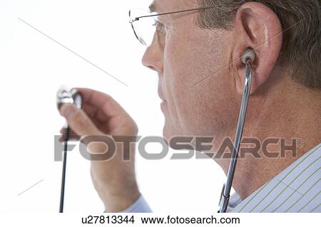 Picture - Doctor holding a stethoscope. Fotosearch