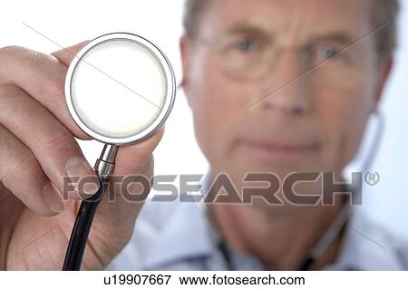 Stock Photo - Doctor holding a stethoscope. Fotosearch