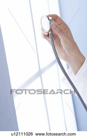 Stock Photograph - Doctor holding a stethoscope. Fotosearch